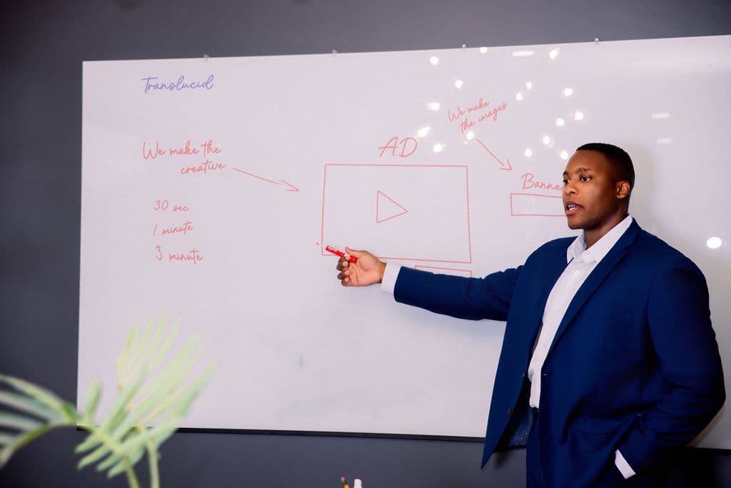 Lyndon Hector speaking at a whiteboard